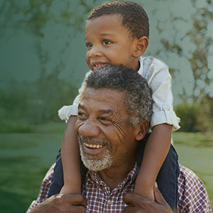 grandfather with grandchild on shoulders