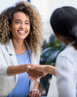 two women shaking hands