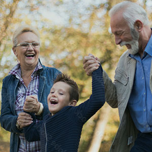 grandparents holding hands with their grand child