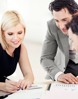 group of people looking over paperwork