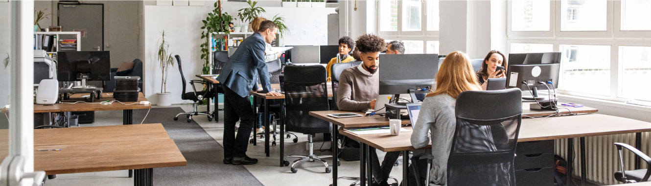 people sitting at their desks at an office