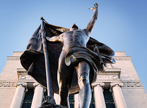 statue of man with building in background